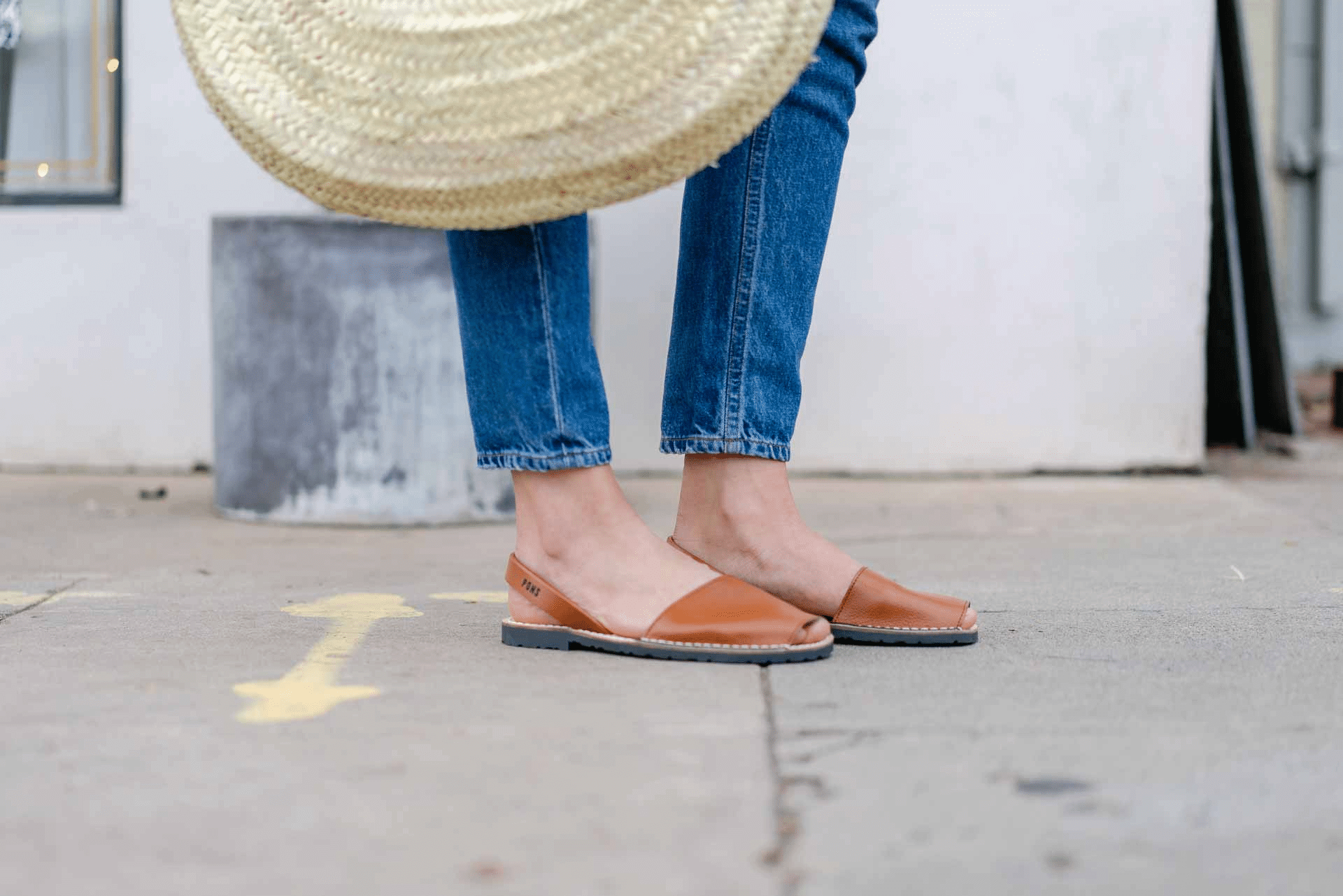 Frau steht auf der Strasse und trägt Pons der Marke Menorca Sandals.